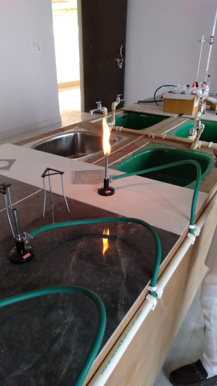 A lit burner on the bench of the chemistry laboratory