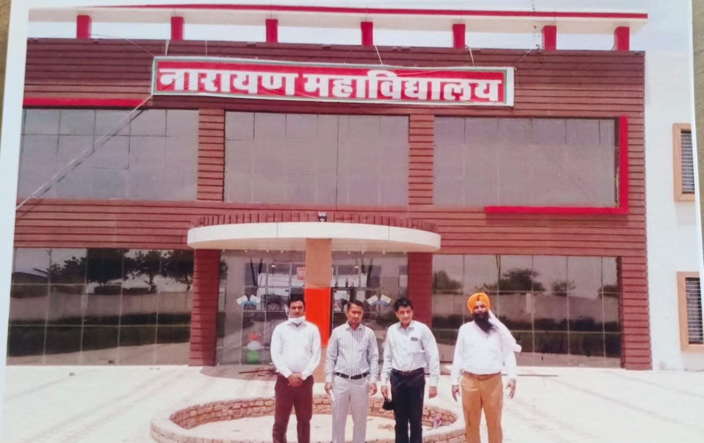 Faculty members standing at the main entrance of Narain College, beneath the Narayan Mahavidyalaya sign