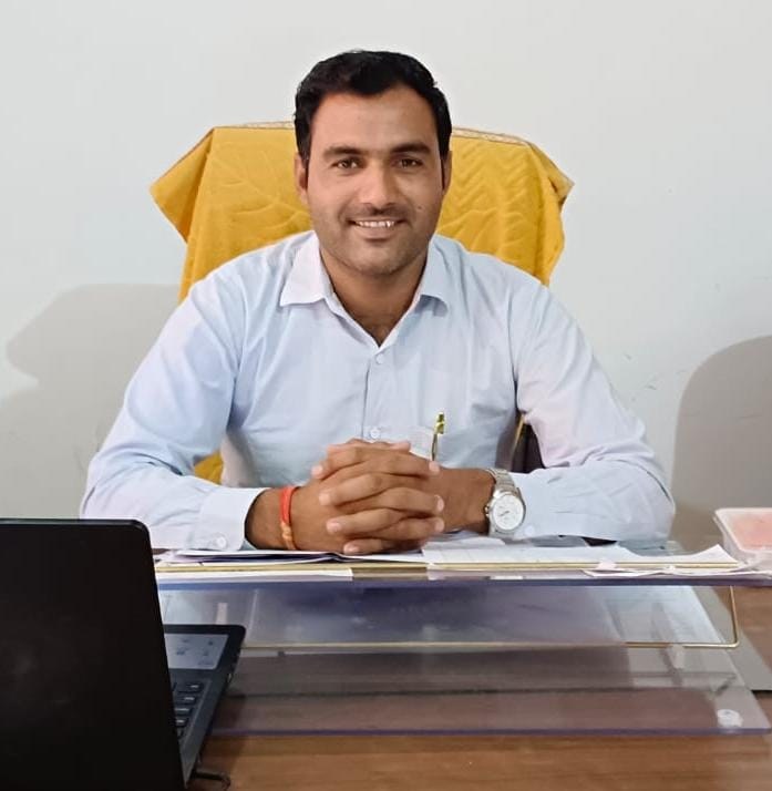 Baljeet Singh Bishnoi at his desk in the college office